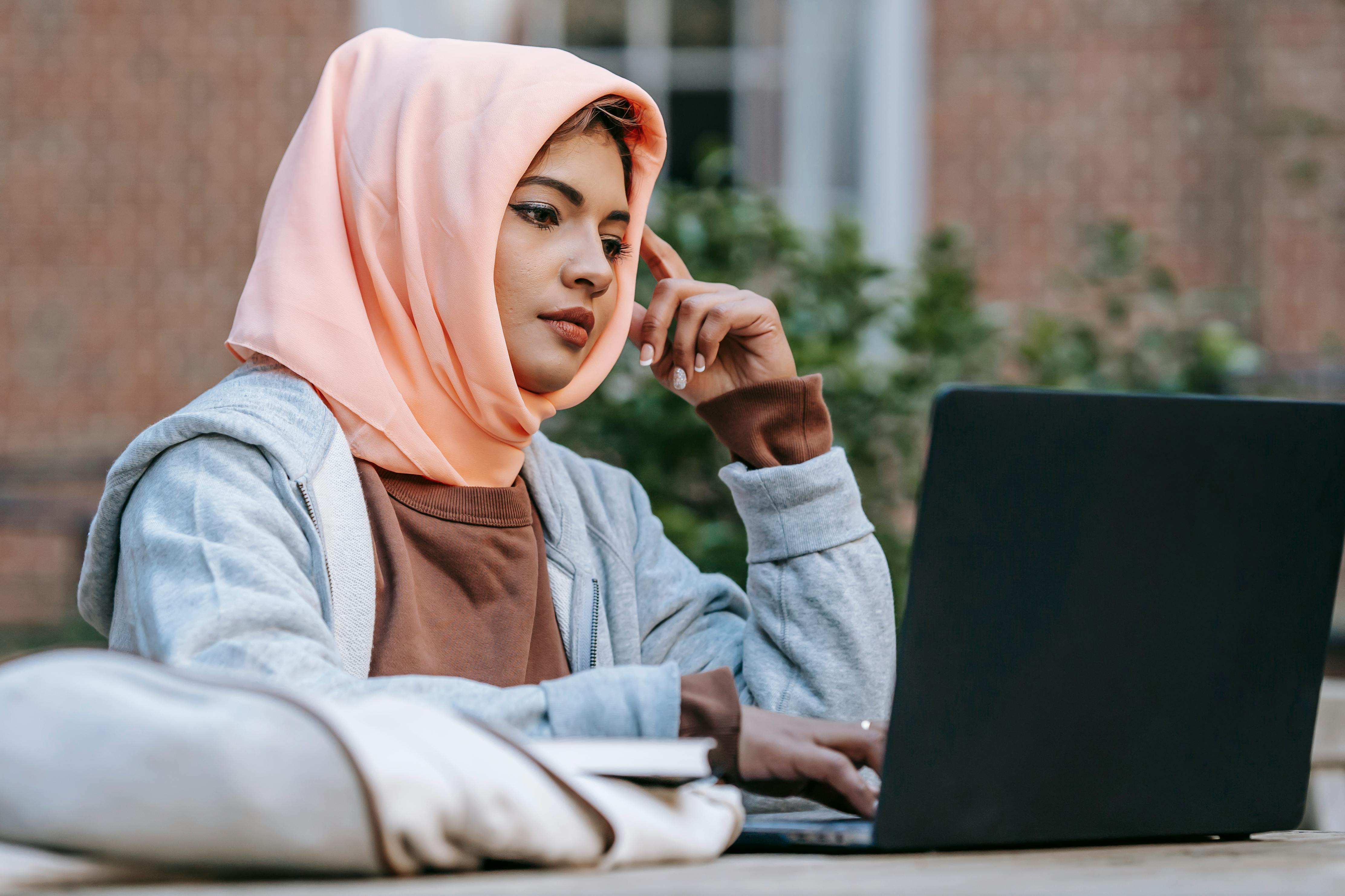 Woman looking at her laptop and learning about the future perfect tense in English
